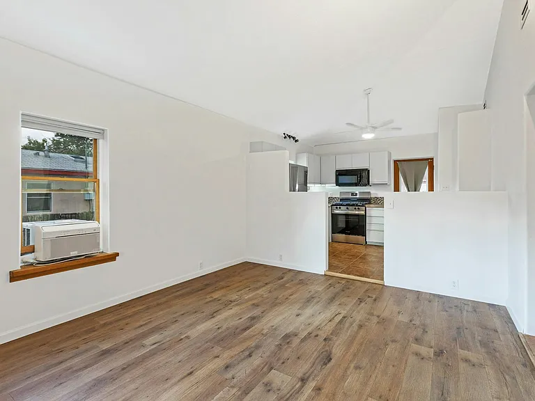 Living/dining area with tall ceilings.