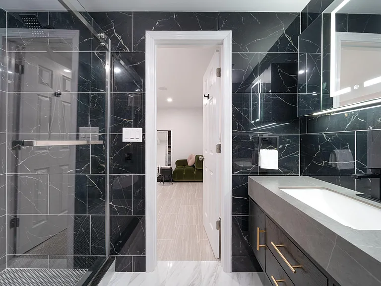 Lower level/basement bedroom includes a private ensuite bathroom with a step-in rain shower for your comfort.