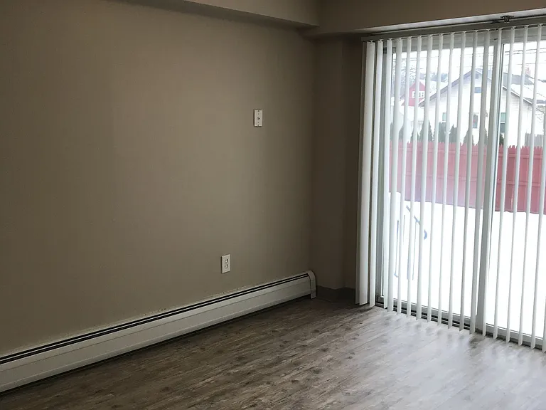Room with Sliding Door and Wood Floors