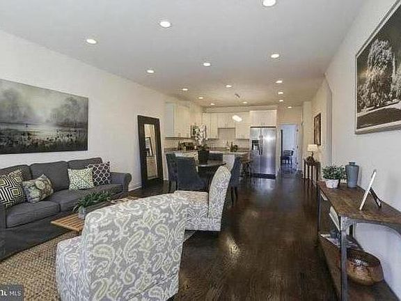 View from front entrance - living room, dining room, and kitchen. . (Unit will not be furnished.)