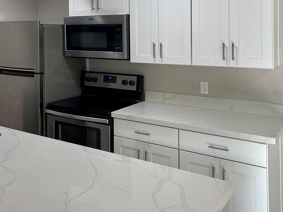 New cabinets, quartz countertops, appliances, and lighting.