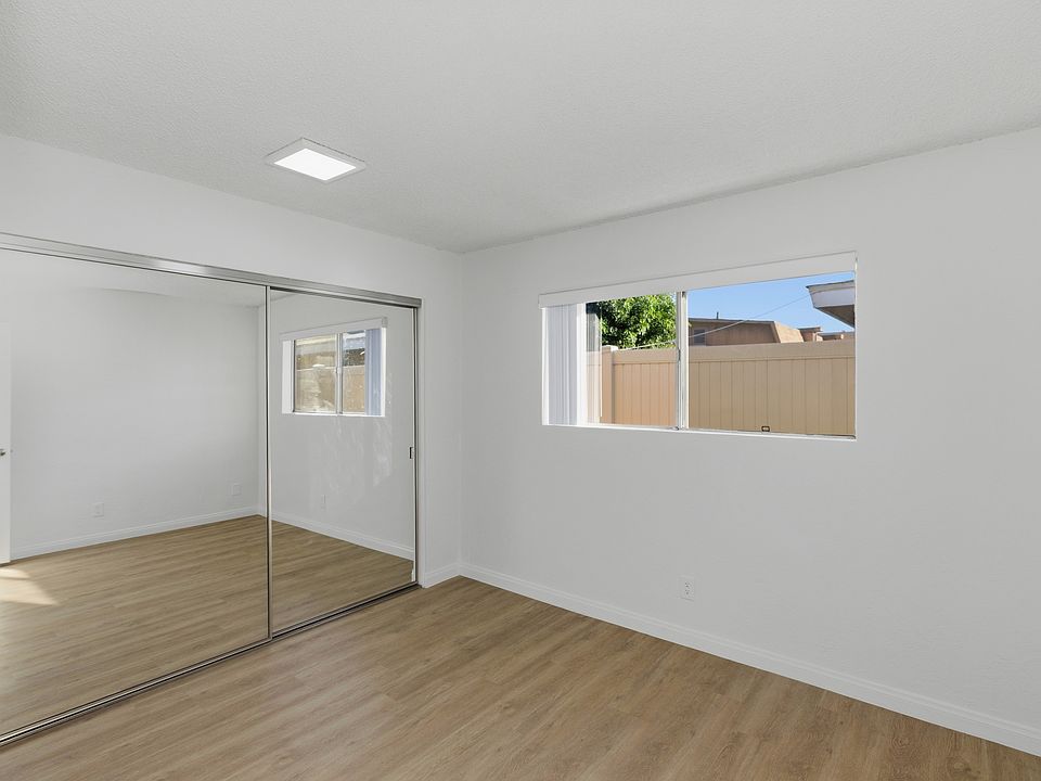 Bedroom 1 w/ Mirror Closet Doors, Large Closet Space, & New Vertical Blinds