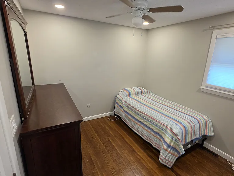 4th bedroom with single bed, dresser and ceiling fan.