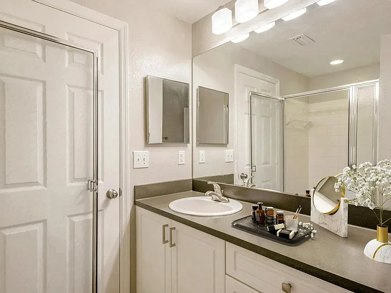 Large mirror vanities and plentiful storage in bathrooms.