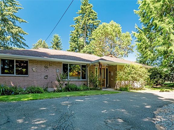 The brick front of the home with covered entry is private & welcoming