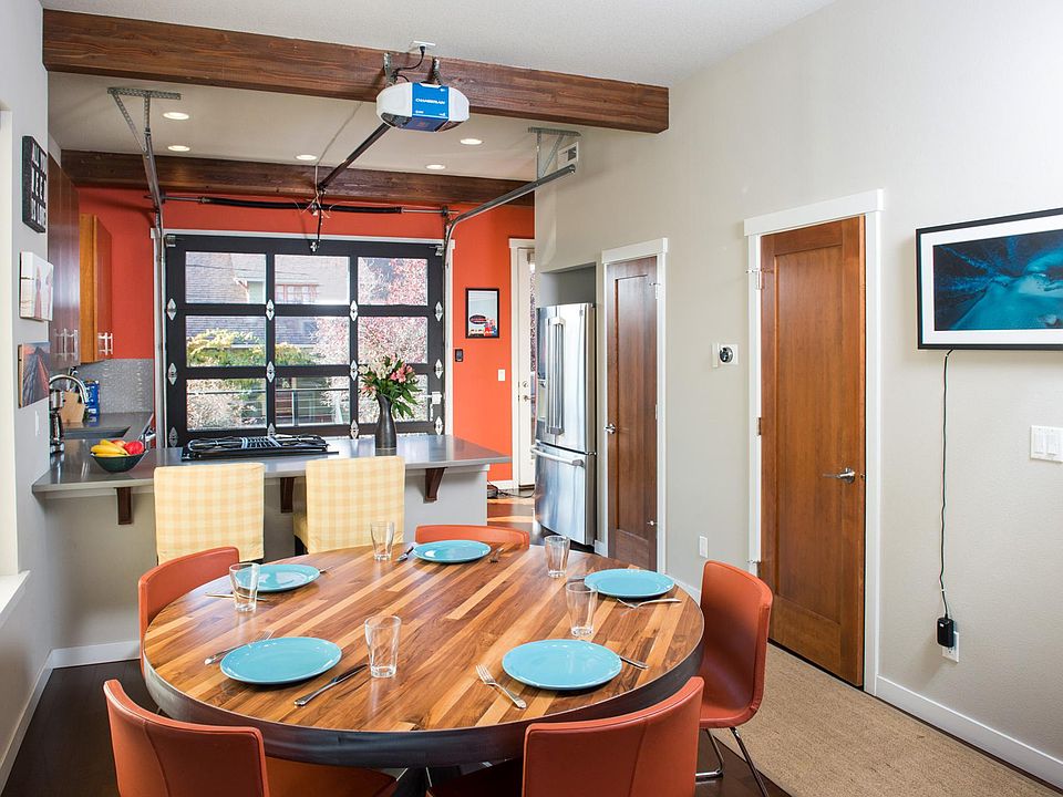 Dining Area & Kitchen w/ Garage Door to Balcony