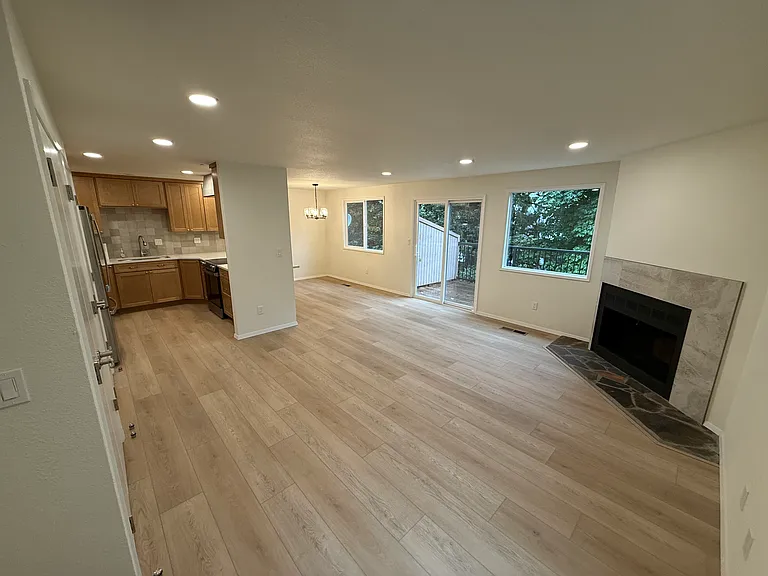Main level- open living, all new kitchen with pantry closet, large breakfast bar, dining area, tiled wood burning fireplace, sliding door to back deck (overlooking treed yard), and large coat/storage closet.