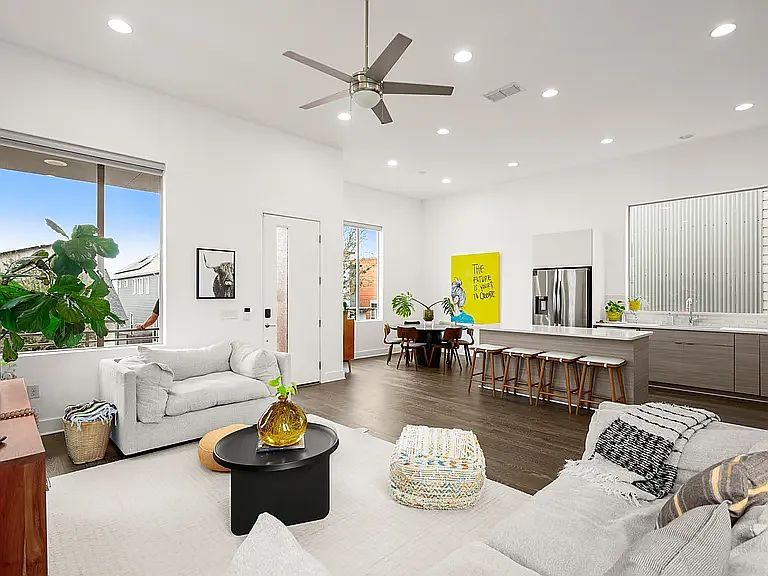 Bright, airy, and filled with sunshine, the living room is wrapped in windows, creating an open and inviting space perfect for relaxing or entertaining.