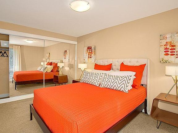 Large bedroom with mirrored closet doors