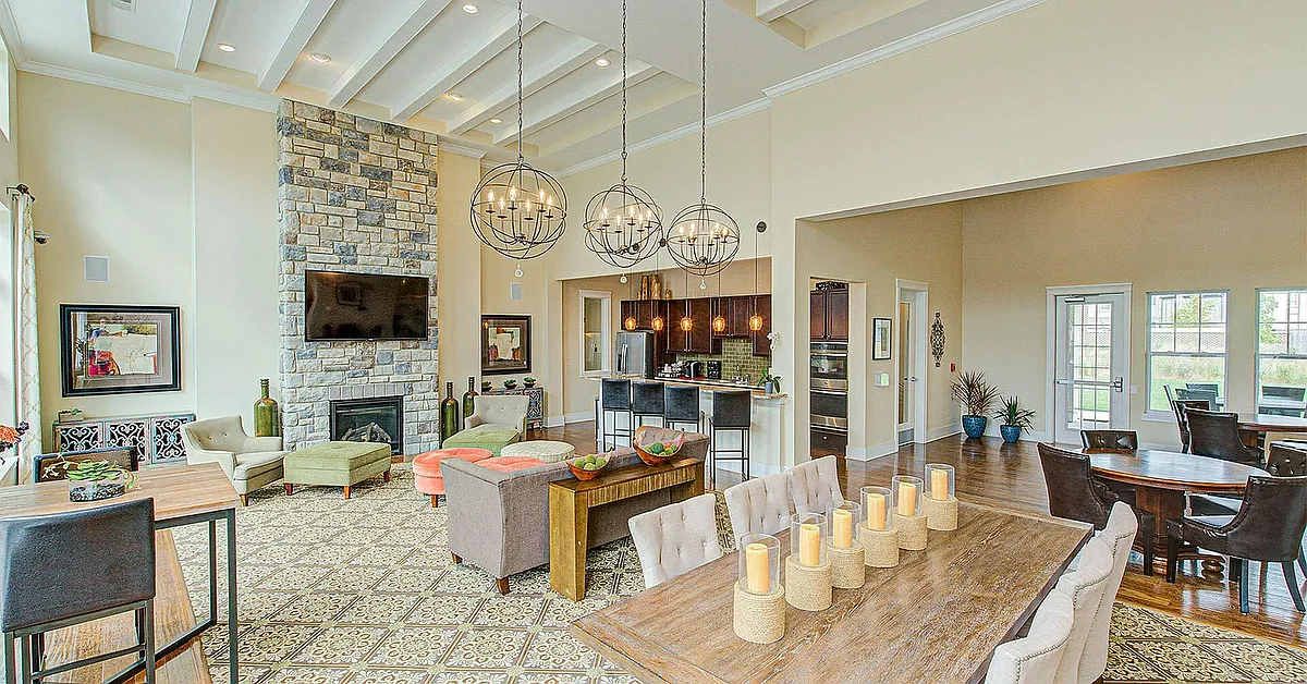 Kick back or catch up in our cozy resident lounge _ with a brick fireplace, TV, dining space, and community kitchen, it's your go-to hangout spot. - The Ivy Towns + Flats