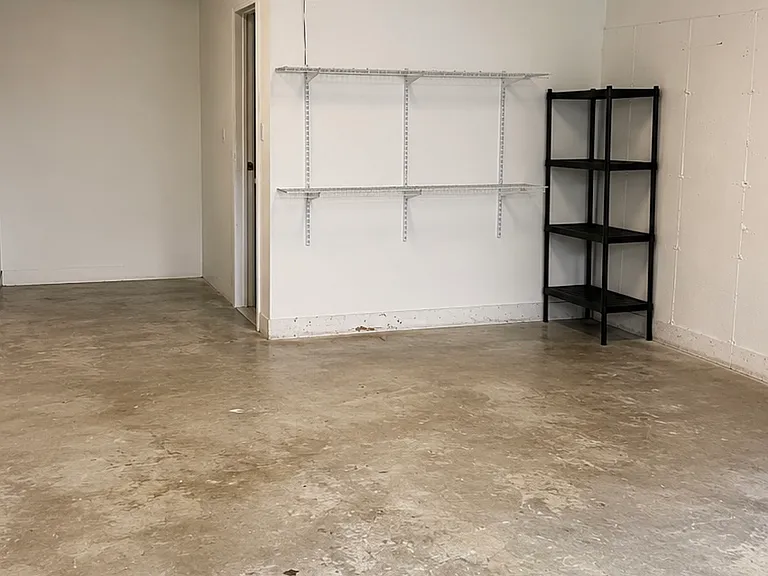 Attached garage for one parking space. Also bonus space for storage. Directly below first floor.