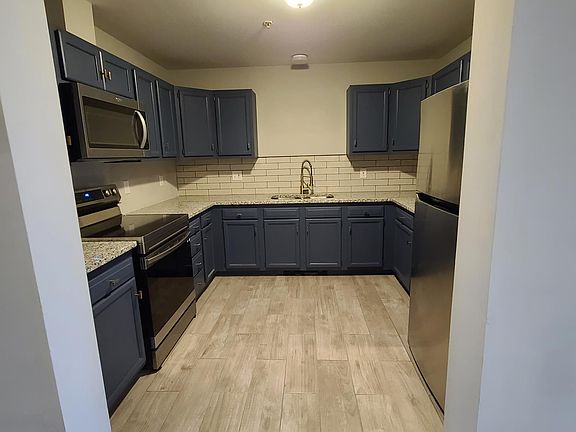 Renovated kitchen - new tile floor, new stainless steel appliances, new granite countertop with tile backsplash