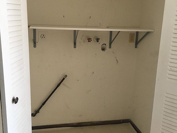 A utility closet with washer and dryer hookups