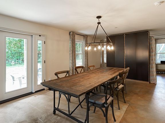 beautiful dining table light. small anti doors on each side of porch doors to left with screens let in a nice breeze.