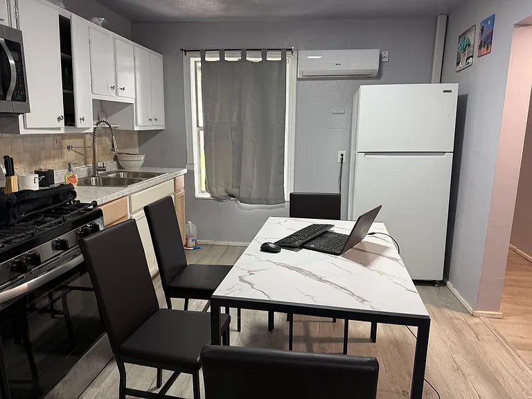 Eat-in kitchen with a full appliance package, generous cabinet storage, and a dining table for everyday meals.