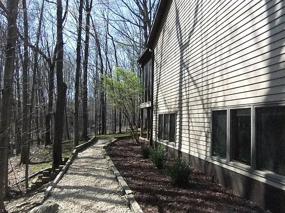 Stone path leads to rear yard.