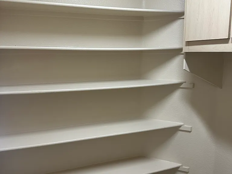 Storage/pantry in the laundry room as well as built-in cabinets above laundry machines/dryer area.