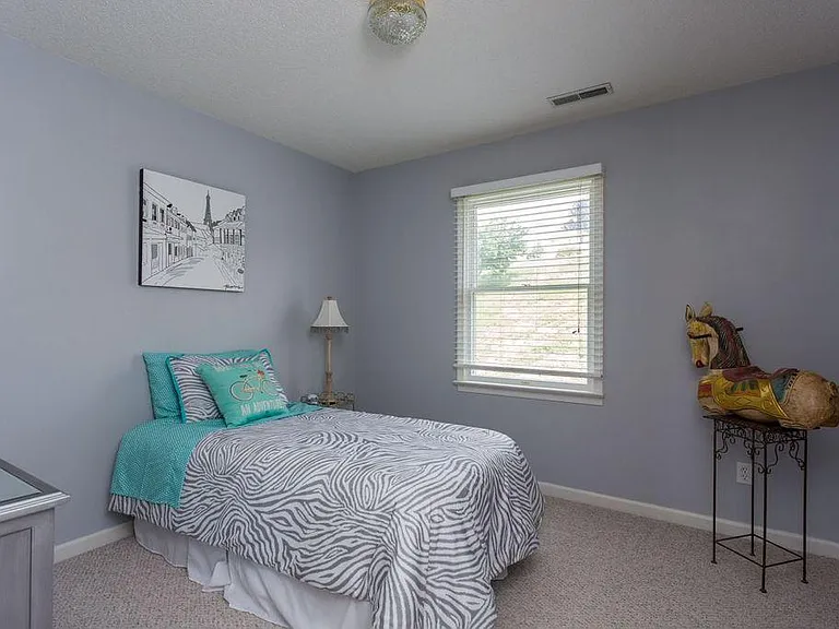 Upstairs bedroom showing twin bed. Huge walk in closet.