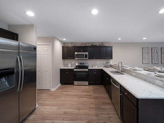 Open kitchen with luxurious finishes - Azalea townhome in St. Cloud, FL