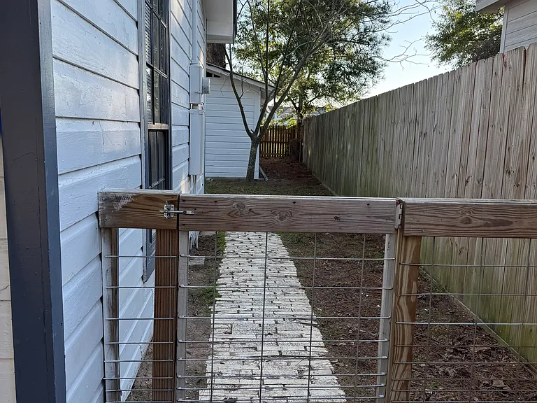 Side gate leading to back yard