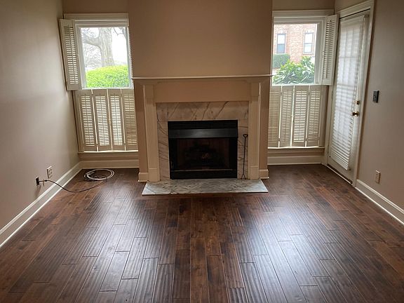 Living room with hardwood floors, gas fireplace, and tons of natural light