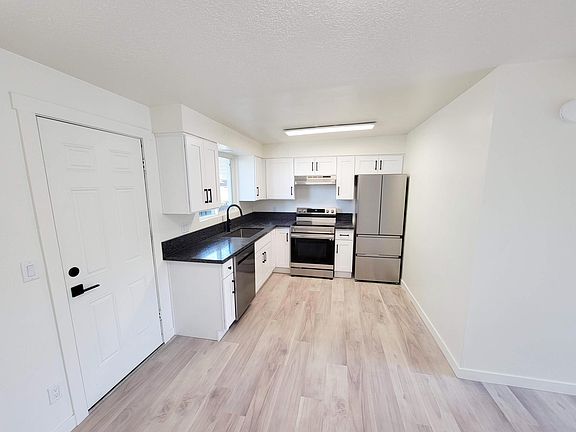 Bright kitchen with all new modern stainless steel appliances. Beautiful wood floors throughout-no carpet!