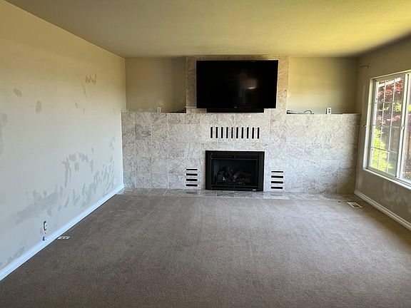 Marble surround for remote controlled gas heat exchanger fireplace. TV over fireplace.