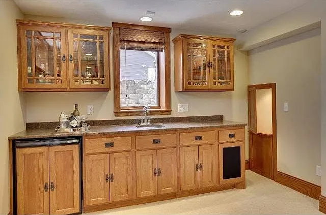 Basement bar with sink and fridge