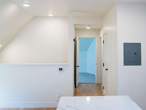 From kitchen, stairwell on the left, bathroom on the right, 2 bedrooms at the end of the hallway.