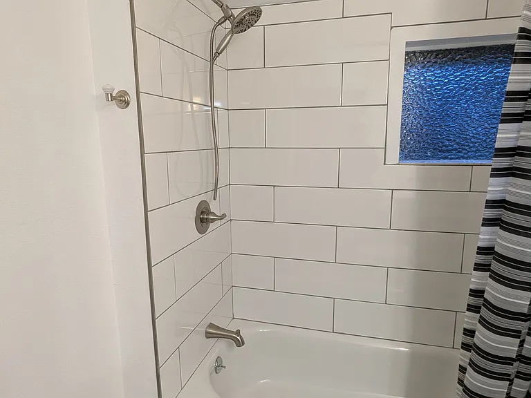 First bathroom, right outside the first and second bedroom, easy for kids or guests.