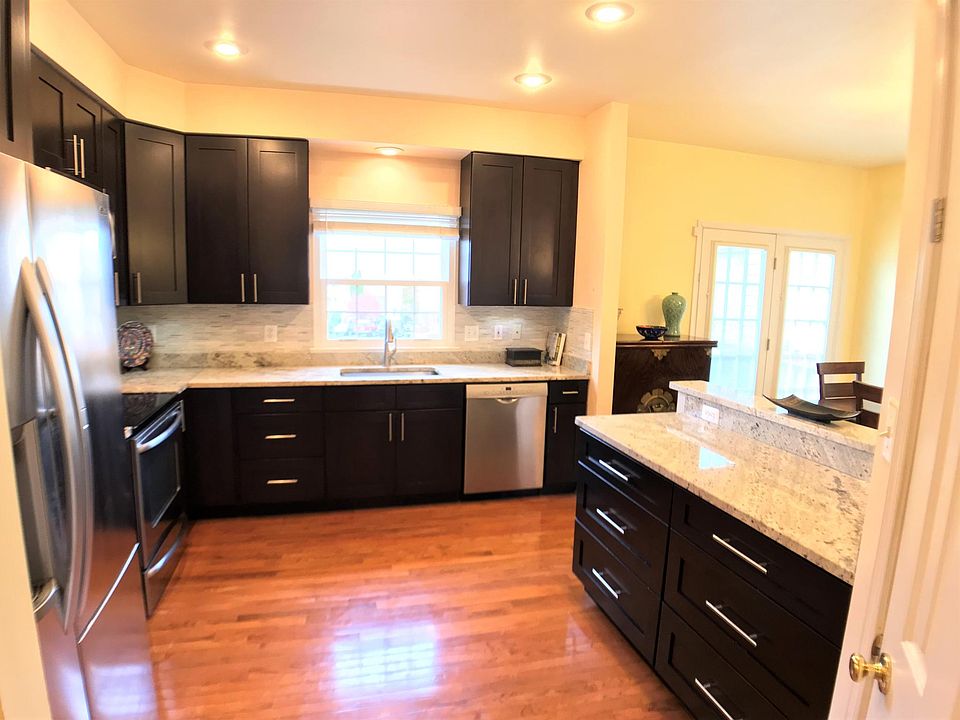 Fully renovated kitchen with stainless appliances, roomy storage, tile back splash and granite counter tops. 42 inch wall cabinets