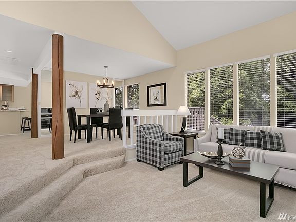 Open floor plan with living and connected dining areas. Lots of windows!