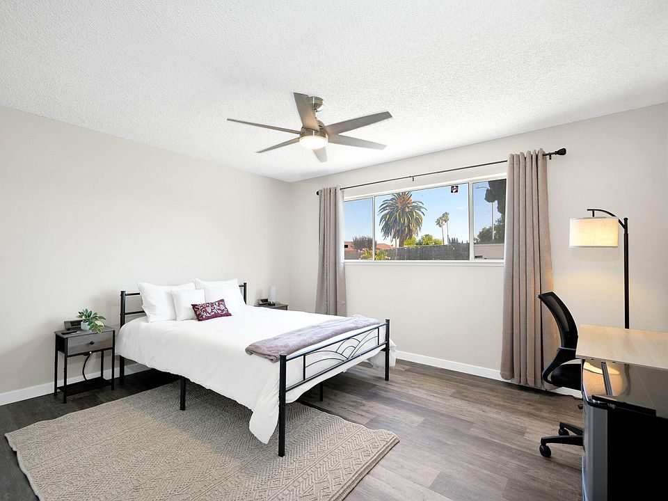 Primary bedroom with large picture window overlooking the backyard