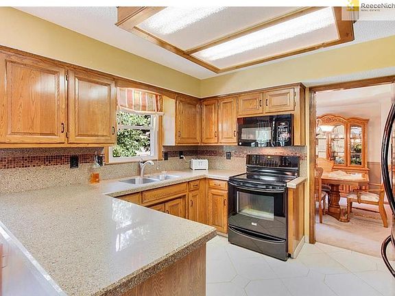 Updated Kitchen.  Refinished cabinets, granite counters, tile backsplash & floors.  Newer appliances