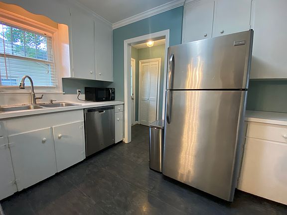 Kitchen area with laundry room behind