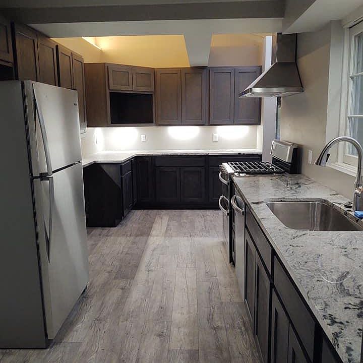 Luxury kitchen with granite, stainless, skylight, dishwasher, garbage disposal, double oven, and double pantry.
