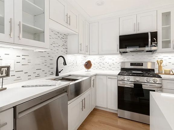 Gourmet chef's kitchen with brand-new stainless appliances and custom cabinetry.