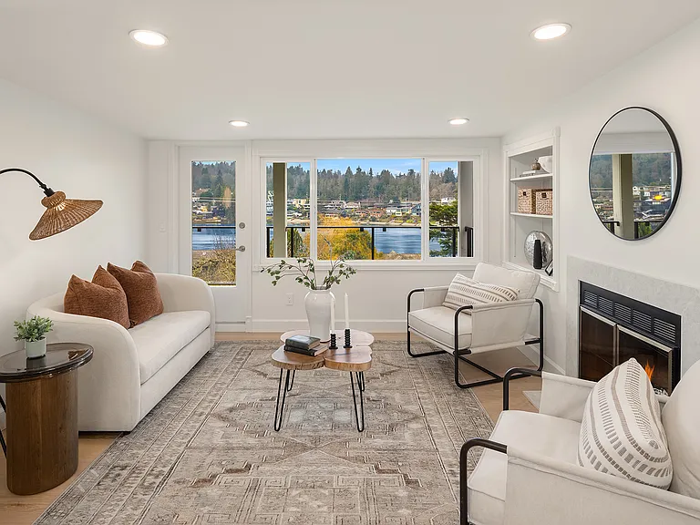 A secondary living room upstairs with a deck and views of Salmon Bay