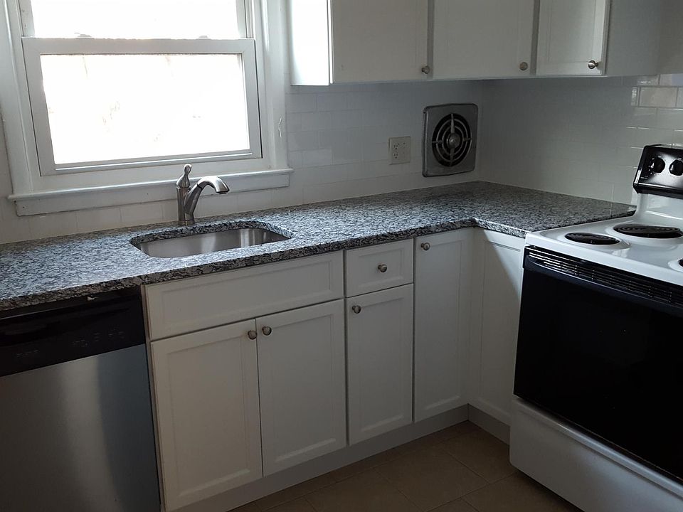 kitchen has electric stove, dishwasher, refrigerator and new