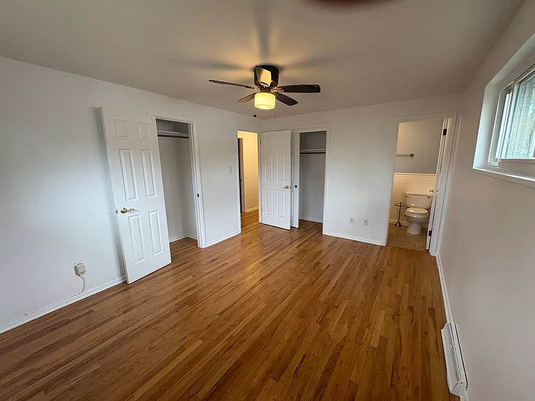 first floor primary bedroom with 2 closets and private bathroom