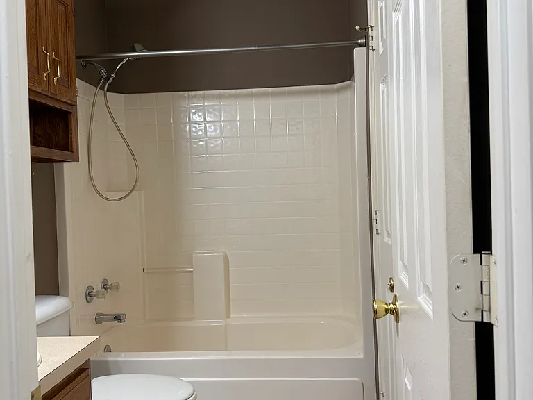 Hallway bathroom view with access door to #1 bedroom.