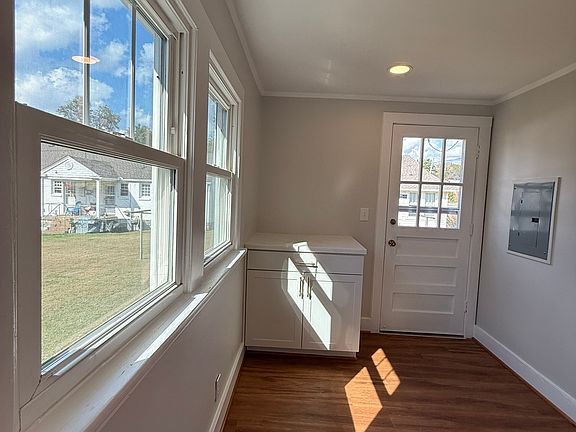 Spacious laundry room with exterior door entrance from covered parking area.