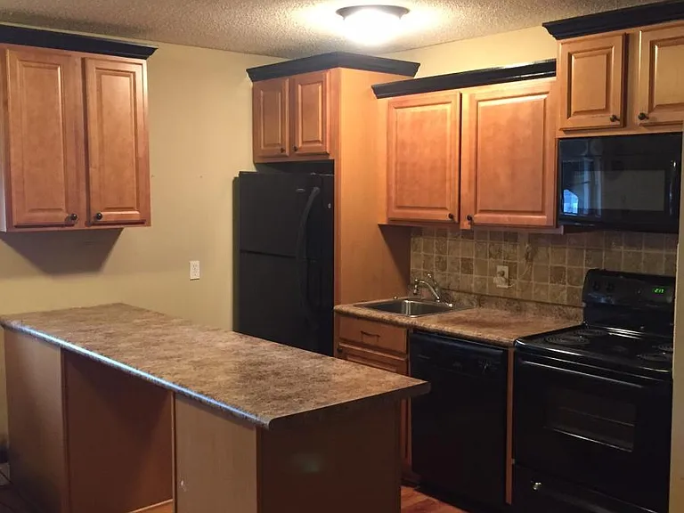 Designer kitchen with tile backsplash & built-in microwave.