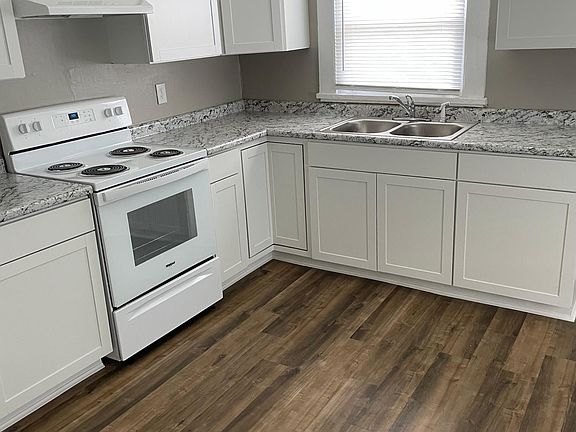 Kitchen with new stove, cabinets, and sink