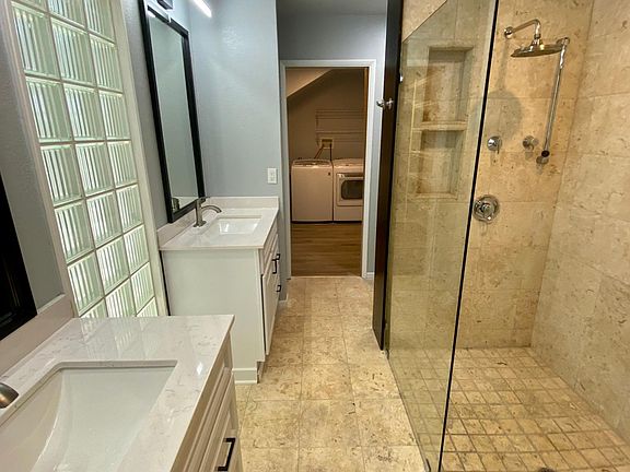 Large Dual Vanity Bathroom with large walk-in shower and walk-in closet with private washer and dryer.