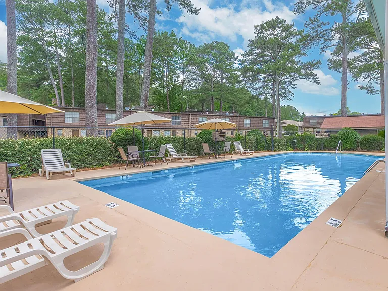 Welcome to Guest House, where relaxation meets elegance. Dive into our beautifully maintained pool surrounded by lush landscaping, perfect for unwinding after a long day. Don't miss out on your new home-visit us today!