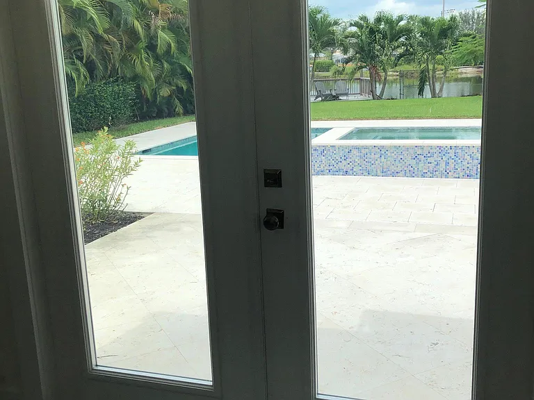 Double doors lead to pool ,spa, , backyard and lake. Fenced in. Safe for children and animals
