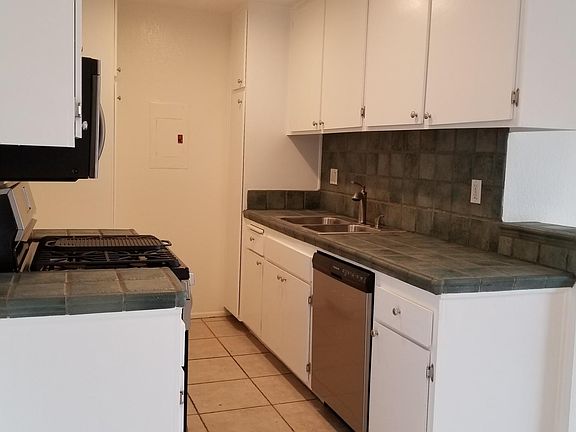 Kitchen with stainless appliances (tile color may vary)