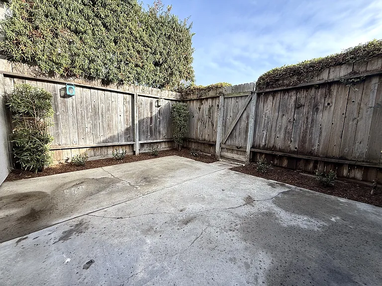 Patio yard with gate to access walkway
