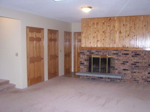 Family room with wood burning fireplace. Lots of storage behind those closet doors. Also 1/2 bath of